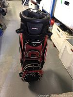 Front view of Bag Boy golf bag showing multiple zippered compartments and wear.