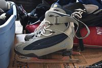 Side view of a single grey and navy blue VIC ice skate showing the blade and overall condition.