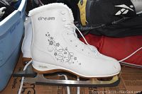 Full side profile of the white Dream ice skate showing floral design and blade