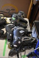 Two men's inline rollerblades on a table with box in background, showing overall condition and style.