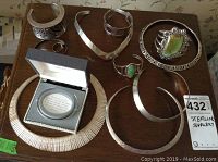 Overview of all sterling silver jewelry pieces on wood table