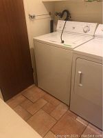 White Inglis Citation Super Capacity Plus washing machine seen next to a dryer in a laundry room.