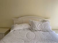 Full view of assembled bed frame with linens