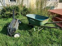 True Temper metal wheelbarrow and Brinley lawn aerator outside on grass showing condition
