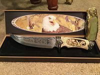 View of the knife in an open display box showing the eagle motif on the handle and the golden eagle head on the sheath.