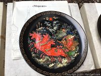 Plate titled Morozko with red horse troika design on black background and gold border