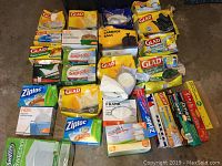 Top view of collection of various household bags including garbage, sandwich, kitchen, and freezer bags primarily from Glad and Ziploc.
