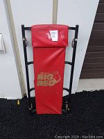 Front view of the Torin Big Red under car roller showing red padded cover with logo and metal frame