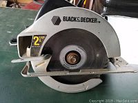 Close-up top side view of Black & Decker circular saw showing blade guard, blade, and branding.