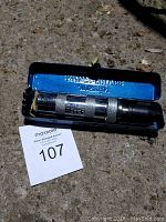 Photo of the Justin impact driver with its blue metal case holding several bit heads, showing condition and included bits.