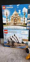 Two boxed LEGO Creator Expert sets stacked: Taj Mahal and Sydney Opera House