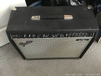 Front view of Fender amplifier with black casing and speaker grille, featuring Fender logo and model name Princeton Chorus.