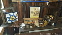 Photo of lots including wooden trays, animal masks, framed picture, and antique iron