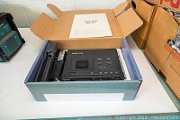 Top-down view of the Tascam HD-P2 portable stereo audio recorder inside the open box with the manual placed on top.