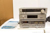 Three vintage Aurex audio components stacked: a tuner on top, amplifier in the middle, cassette deck on bottom. Light wear visible.