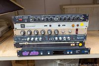 Front view of stacked rack units showing Ashly, JBL, Symetrix, Renkus-Heinz and Audio Digital units