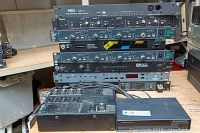 Stacked rack units showing multiple front panels and general wear