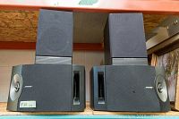 Pair of Bose 201 speakers stacked with Mordaunt Short MS 3.10 on top, showing front grills with hole and light wear