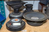 Overview of two 2447J-SL drivers with horns and one E1208-B woofer on table