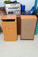 Pair of vintage Calrad wooden speakers with front panels off and visible interior components. Wooden finish with mid-century style.