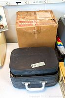 Closed black zippered carrying case containing Sekonic 80J projector and accessories