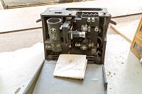 Vintage Victor 16mm projector viewed open showing inner electrical and mechanical components along with instruction manual.