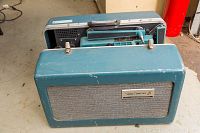 Graflex 16mm projector in its carrying case, showing the teal blue cover detached and placed in front.