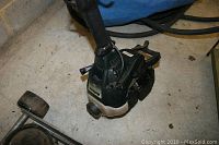 Close-up of the Bolen gas-powered engine head of the weed trimmer, showing black and off-white plastic housing with Bolen label.