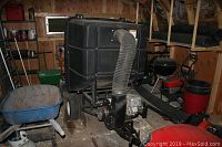 Overall view of pull-behind leaf catcher unit inside shed