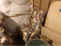 Side angle view of one Queen Anne chair with floral upholstery showing overall condition and fabric pattern.
