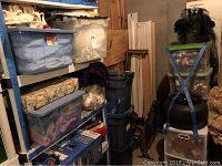 Warehouse shelving with six plastic bins filled with various fabric materials and textiles.