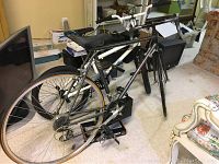 Side view of both bicycles together showing the Fuji road bike foreground and white Mongoose bike behind.