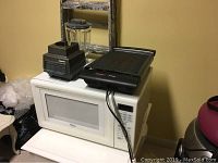 Whirlpool microwave oven with Cuisinart blender and T Fal multi grill on top