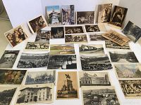 Lot of over 40 vintage postcards spread out showing a mix of black and white, sepia, and color cards depicting European artwork, religious images, and city landmarks.