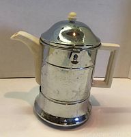 Front view of Ever-Hot coffee pot in chrome holder showing the entire item including spout, handle, lid, and base.