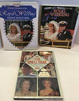 Three books displayed in a group: 'Official Celebration of the Royal Wedding' by Gordon Honeycombe with a white cover, 'Debrett's Book of the Royal Wedding' with a dark cover, and 'The Royal Year - 1989' softcover showing royal family photos.