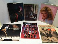 Photo shows six music related books and a music album insert: Janis Joplin Pearl, Carole King Tapestry, Sandi Patti Songs from the Heart, Henry Mancini Breakfast at Tiffany's, James Bond 007 music book, Bruce Springsteen and the E Street Band album insert not sheet music. Covers mostly softcover with music artist photos.