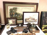 Various framed foxhunting prints and paintings, small framed photos, wooden crate with vintage glass jars and brass figurine, iron tools and hardware pieces.