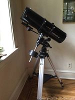 Full view of mounted telescope showing optical tube, equatorial head, counterweight and tripod