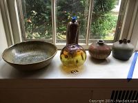 Full set of signed pottery and blown glass ball shown on windowsill.