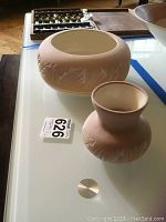 Photo shows an overhead front view of the Southwestern style pottery bowl and vase together on a table surface, displaying the etched leaf patterns and matte surface.