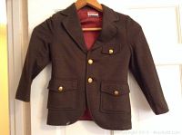 Front view of young boy's brown dress coat with brass-colored buttons