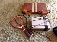 View of all lot items showing Nintendo console, two Breyer horses, leather Backgammon case, and two racketball rackets.