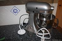 Full view of mixer on countertop with bowl and attachments