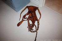 Front view of the brown three-dimensional leather wall sculpture showing the detailed craftwork and abstract design.