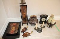 All items arranged together showing platter, turtles, candle stand, ceramic jar, candlestick, candles, and clock