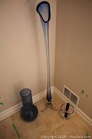 Photo showing all three glass vases together from a distance, highlighting the tallest slender blue vase with clear tripod base, medium blue bulbous vase, and small clear vase with black accents.