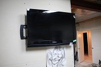 Front view of Samsung TV mounted on the wall showing the screen and frame.