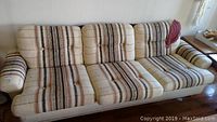 Full front view of three-seat striped sofa