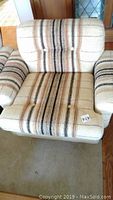 Front view showing full seat and arms upholstered in striped fabric